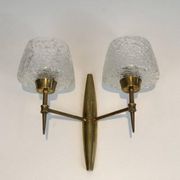 Pair of bronze wall sconces with worked glass reflectors. Stilnovo