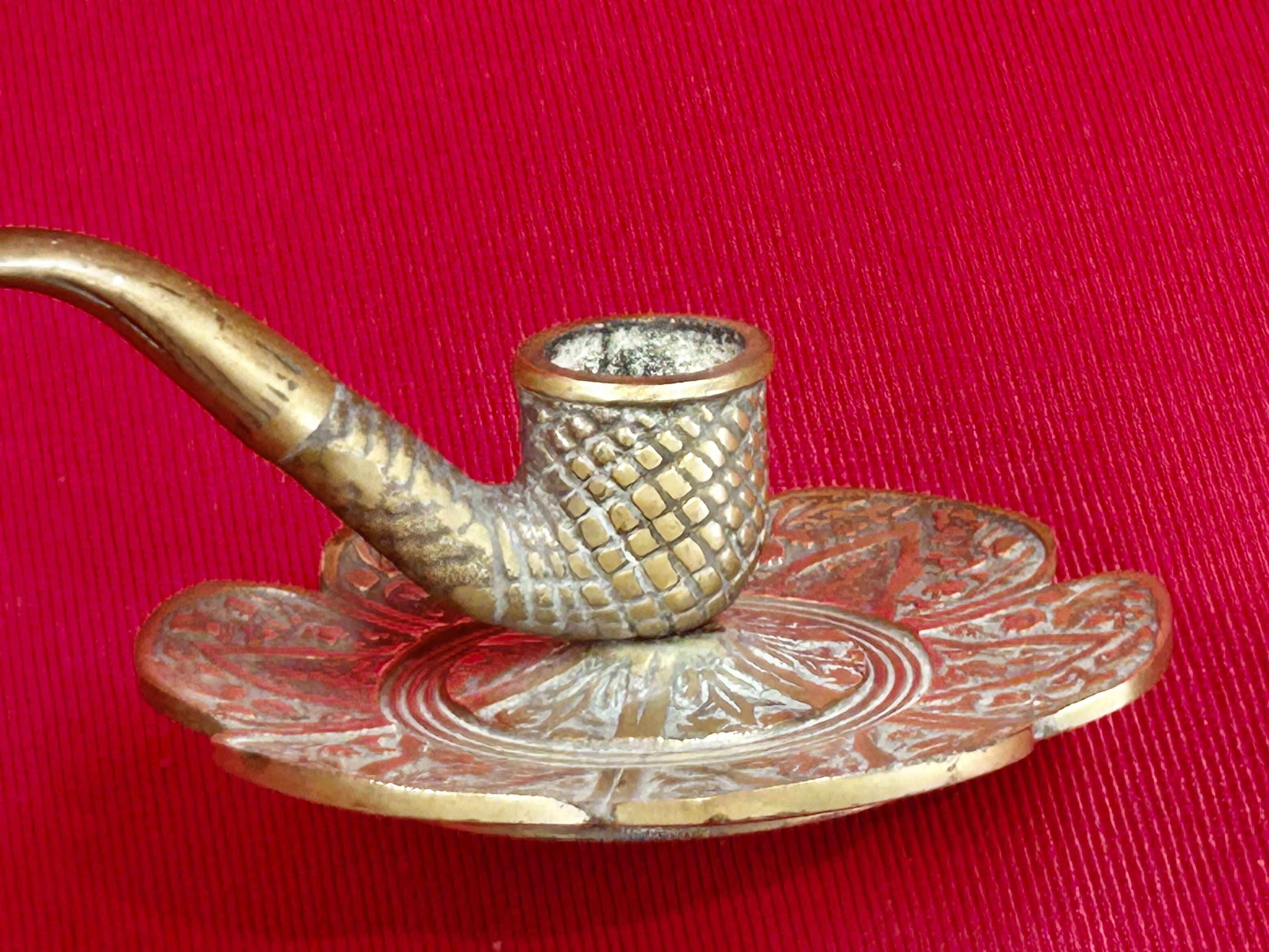 antique hand candlestick known as a rat of the cellar in bronze art Pipe