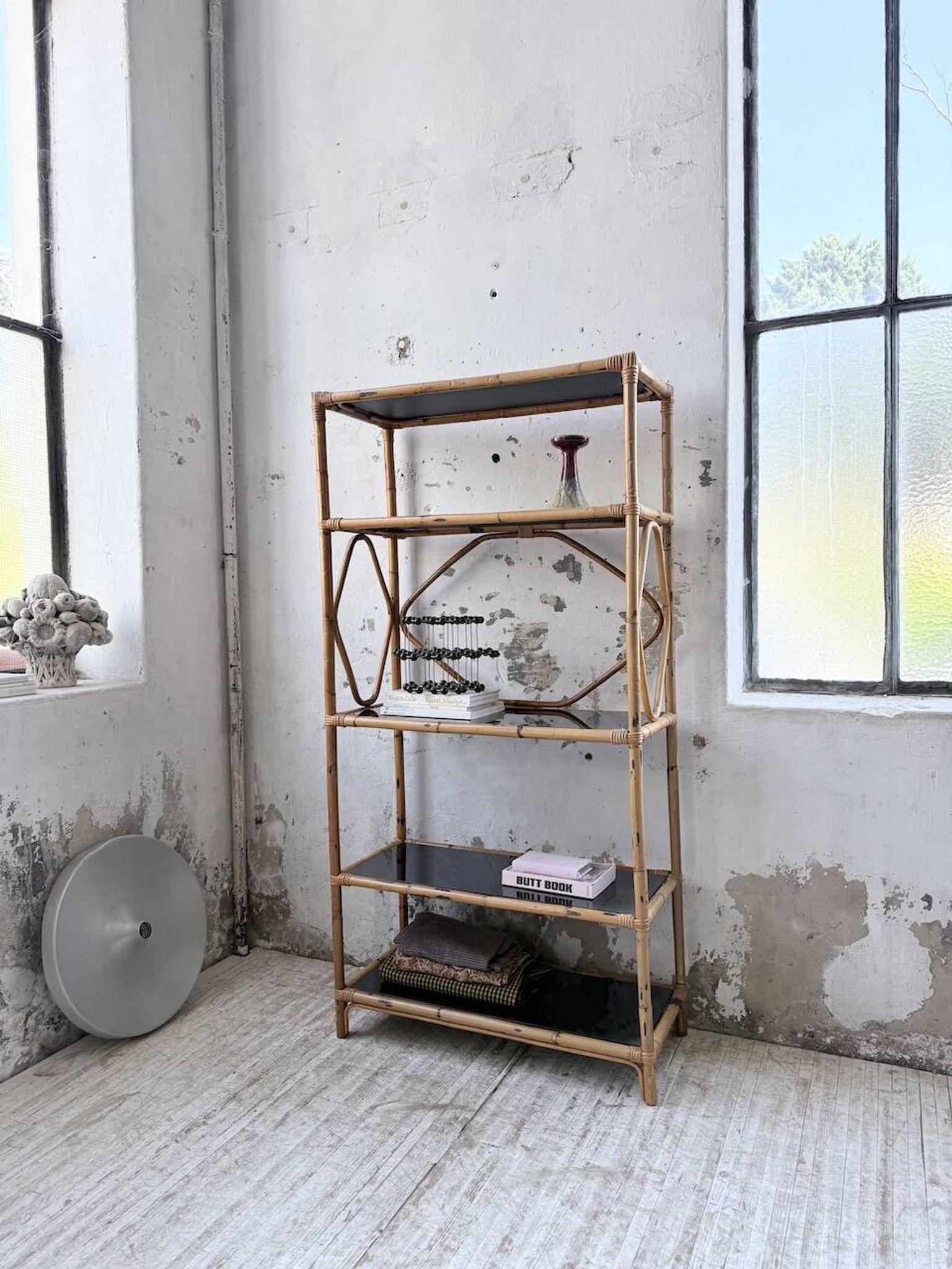 Rattan bookshelf and black glasses
