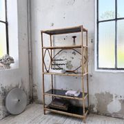 Rattan bookshelf and black glasses