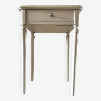 Old patinated beige bedside table