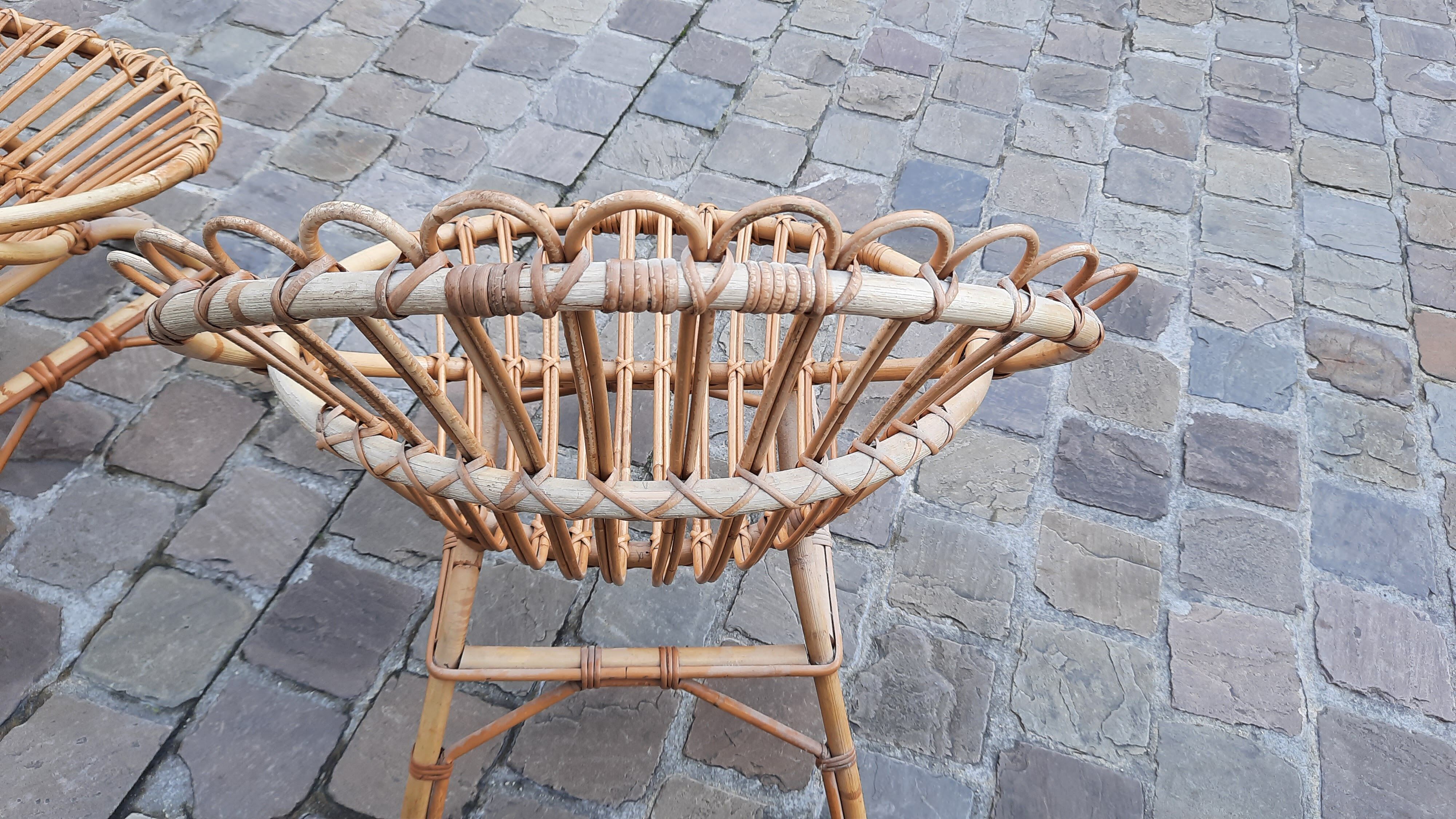 Pairs of shell rattan armchairs from the 50