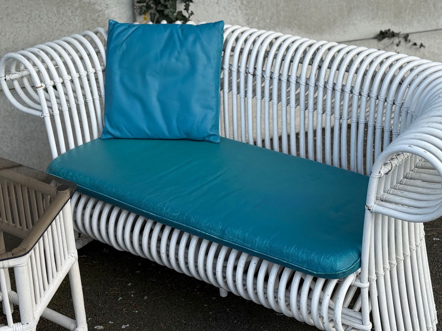 Rattan lounge with two two-seater sofas and a white coffee table.