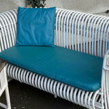 Rattan lounge with two two-seater sofas and a white coffee table.