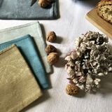 Suite of four tinted antique napkins