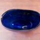 Blue blown glass vase and orange inclusion