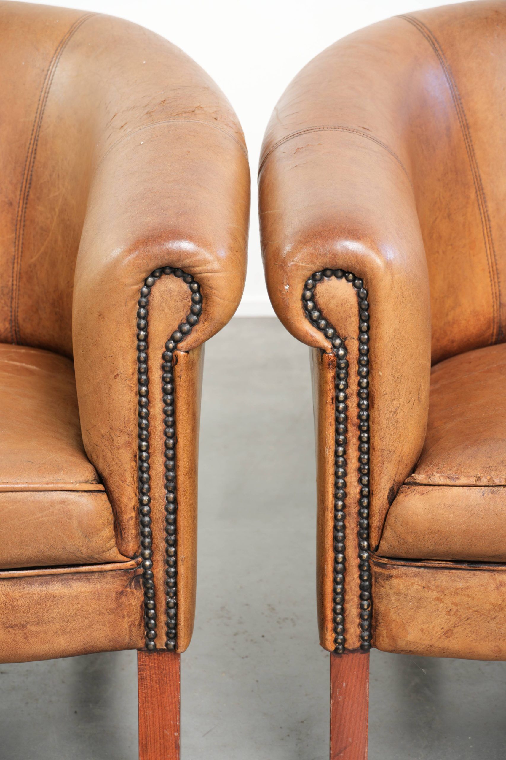 Set of two vintage sheepskin club armchairs with a beautiful light colour