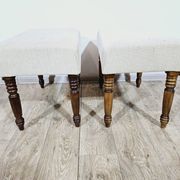 A pair of English upholstered pouffes/footstools from the 19th century