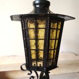 Large hanging lantern in wrought iron and opaque yellow-orange windows