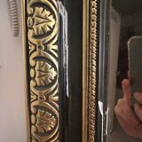 Napoleon III mirror with a pediment featuring black and gold dragons and birds.