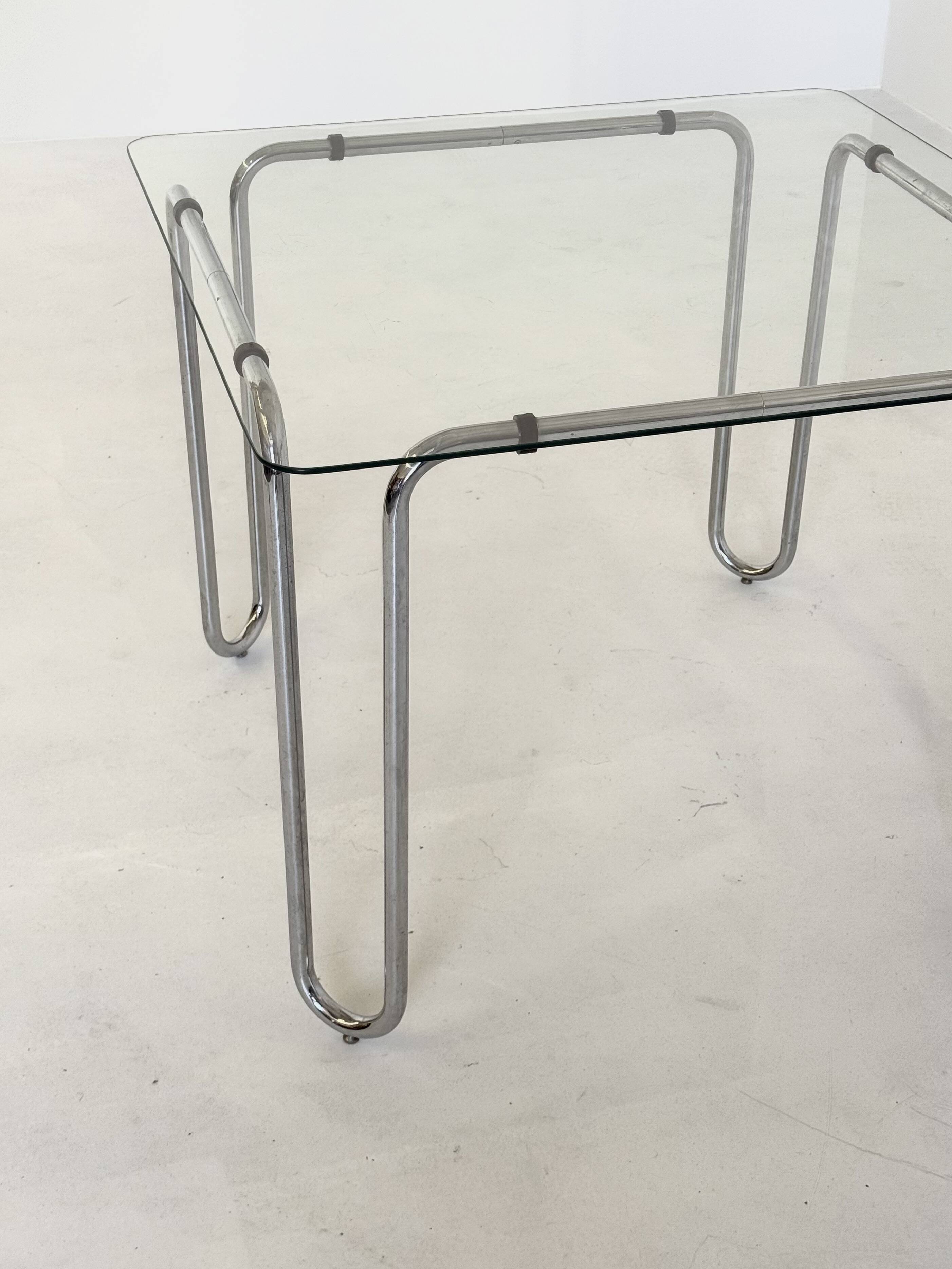 Italian vintage dining table with smooth glass and tubular frame base