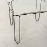 Italian vintage dining table with smooth glass and tubular frame base