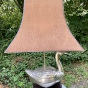 Old vintage lamp representing a duck in silver metal with wooden base