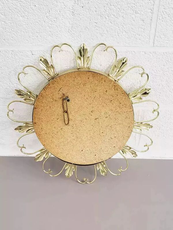 Miroir rond sur cadre laiton à volutes