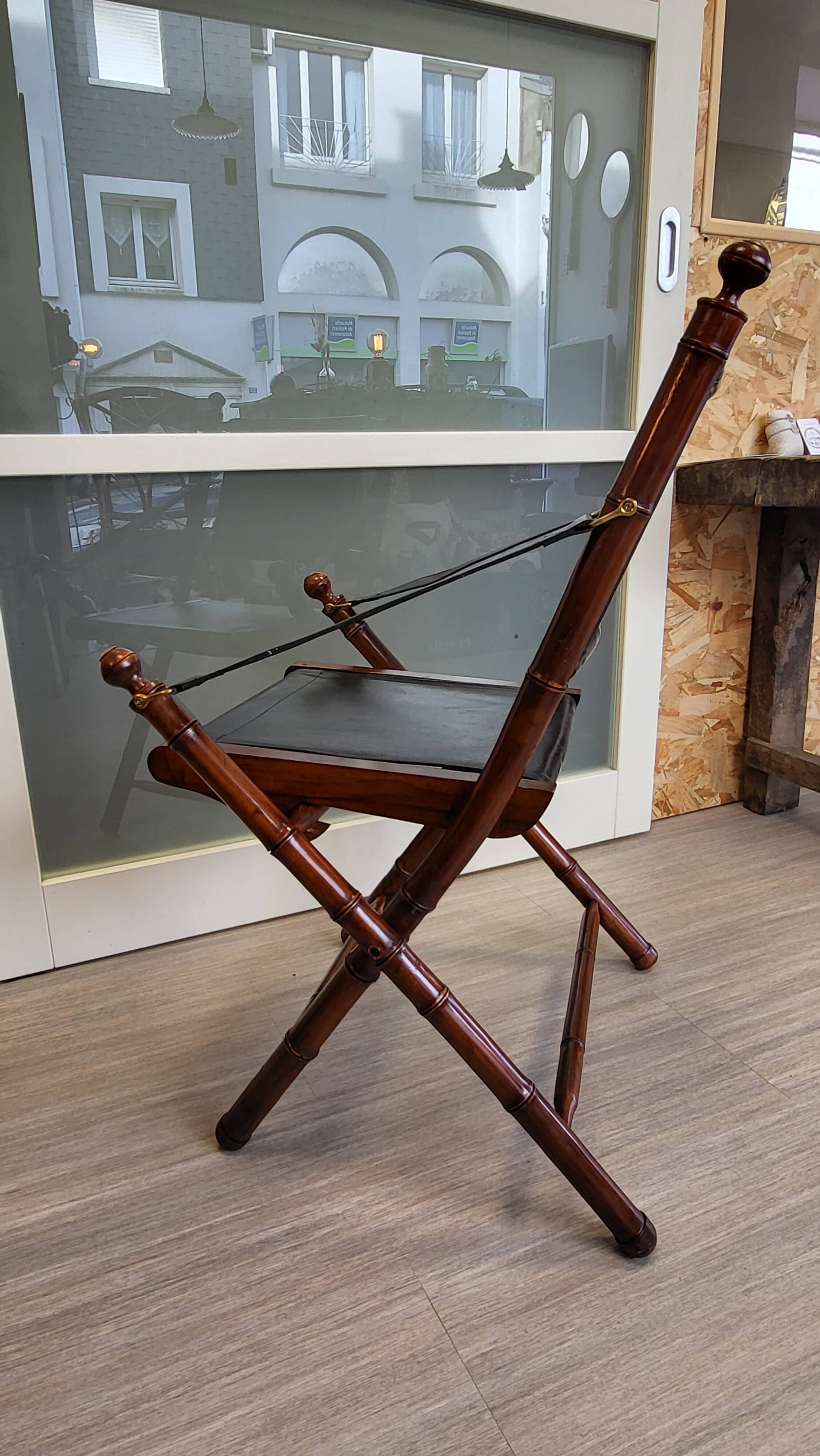 Colonial style folding leather and teak armchair