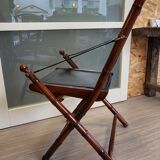 Colonial style folding leather and teak armchair