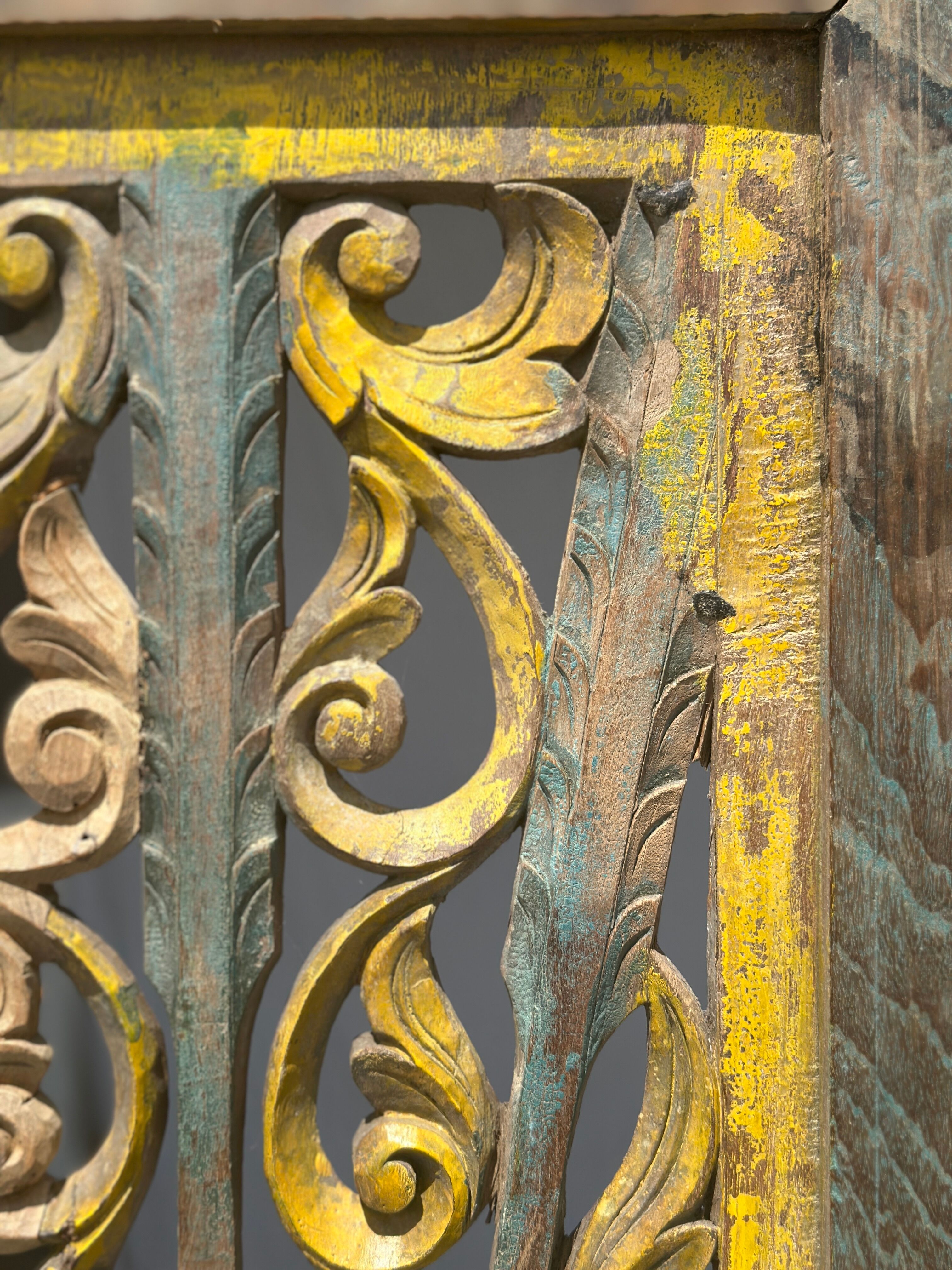 Rectangular Indonesian construction element with blue and yellow plant in carved wood