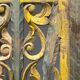 Rectangular Indonesian construction element with blue and yellow plant in carved wood