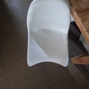10 white chairs in the style of Verner Panton