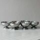 Set of 6 silver stainless steel ice cream bowls on a stand.