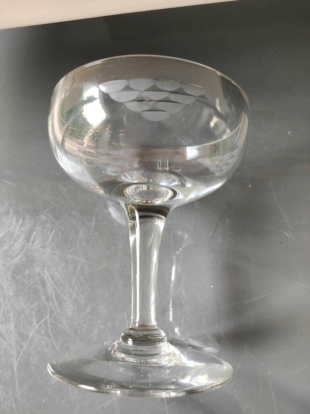 Set of 6 Baccarat-style champagne glasses. Stylized grape cluster decoration.