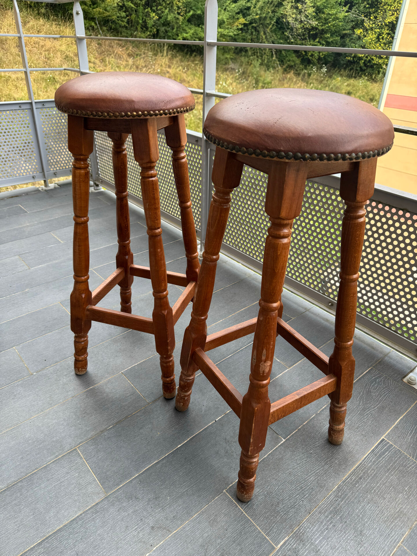pair of vintage wooden and leather bar stools