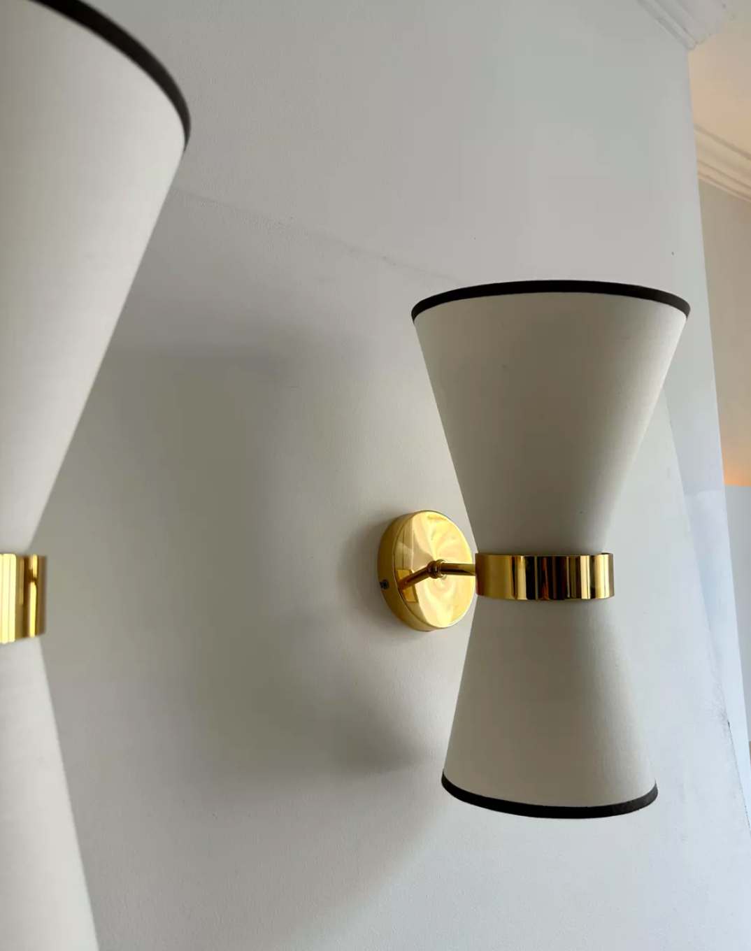 Pair of vintage wall lamps, solid brass and unbleached fabric, Italy 1980