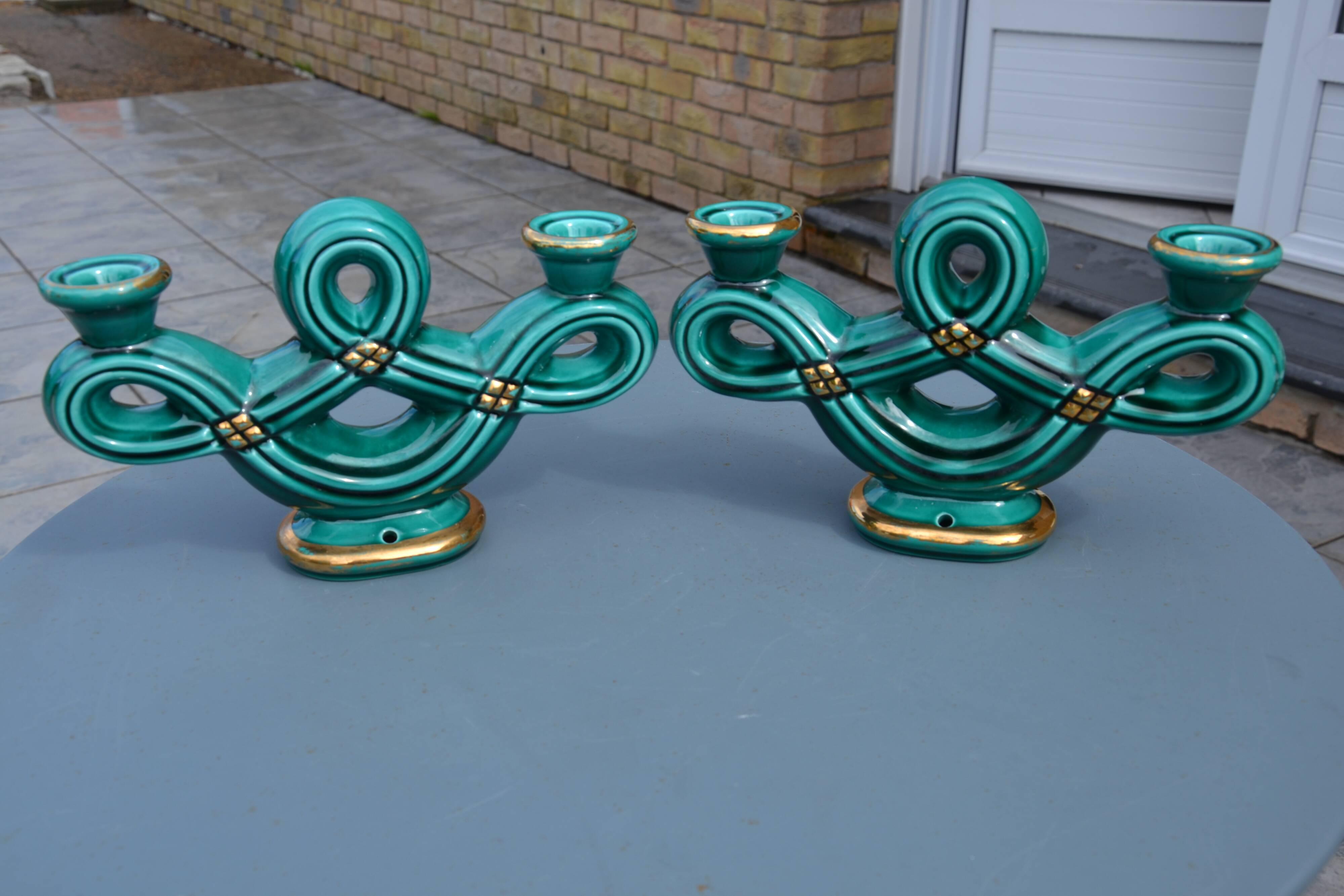 Two green ceramic candlesticks from the 1930s-1940s.