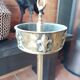 Ashtray on foot. Bronze and brass, with fleur-de-lis decoration.