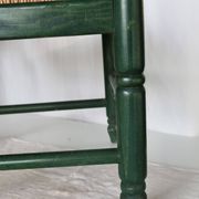 Vintage children's chair in green wood with a woven straw seat