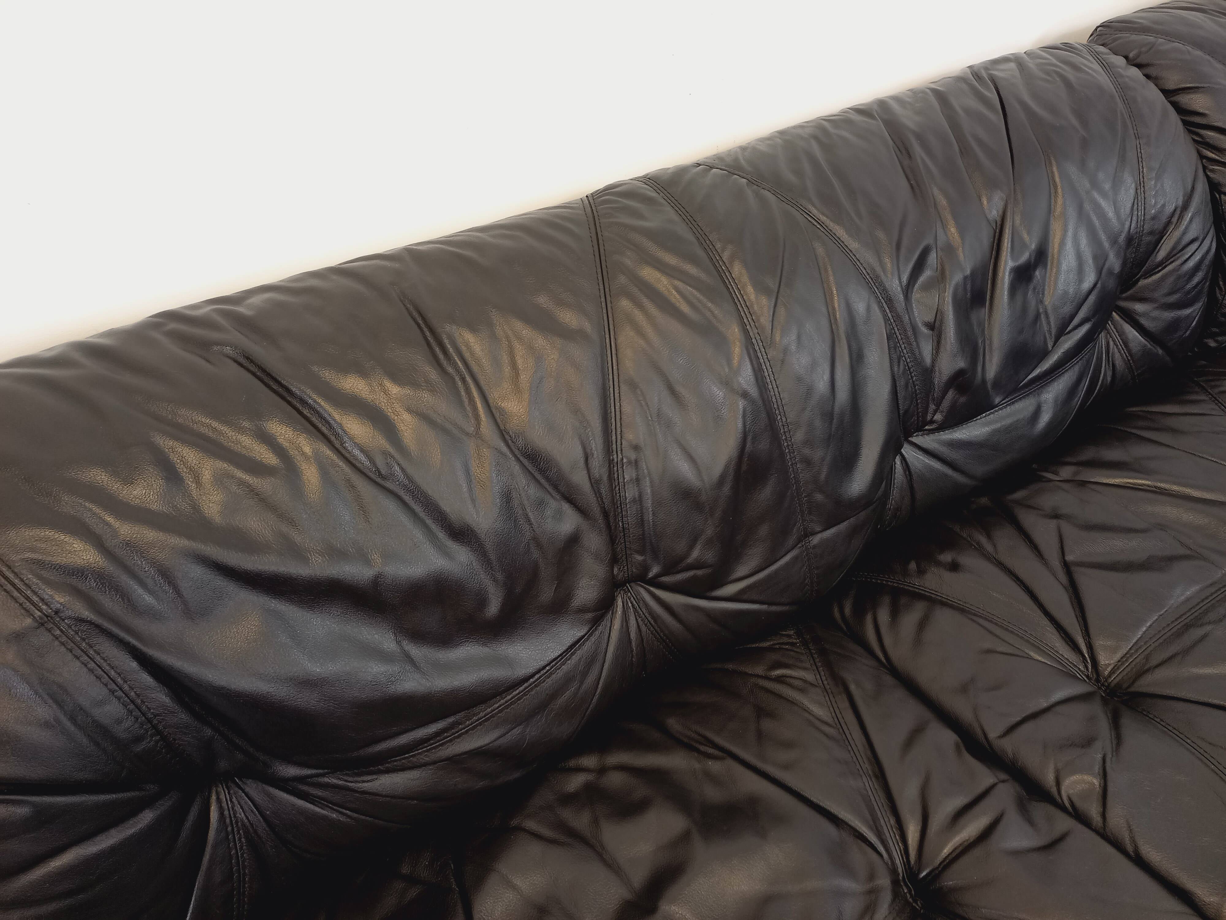 Vintage corner sofa composed of 3 modules in black leather with integrated bed.