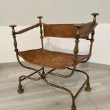 Curule leather armchair