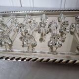 A charming set of 12 molded glass knives rests in the shape of a dog