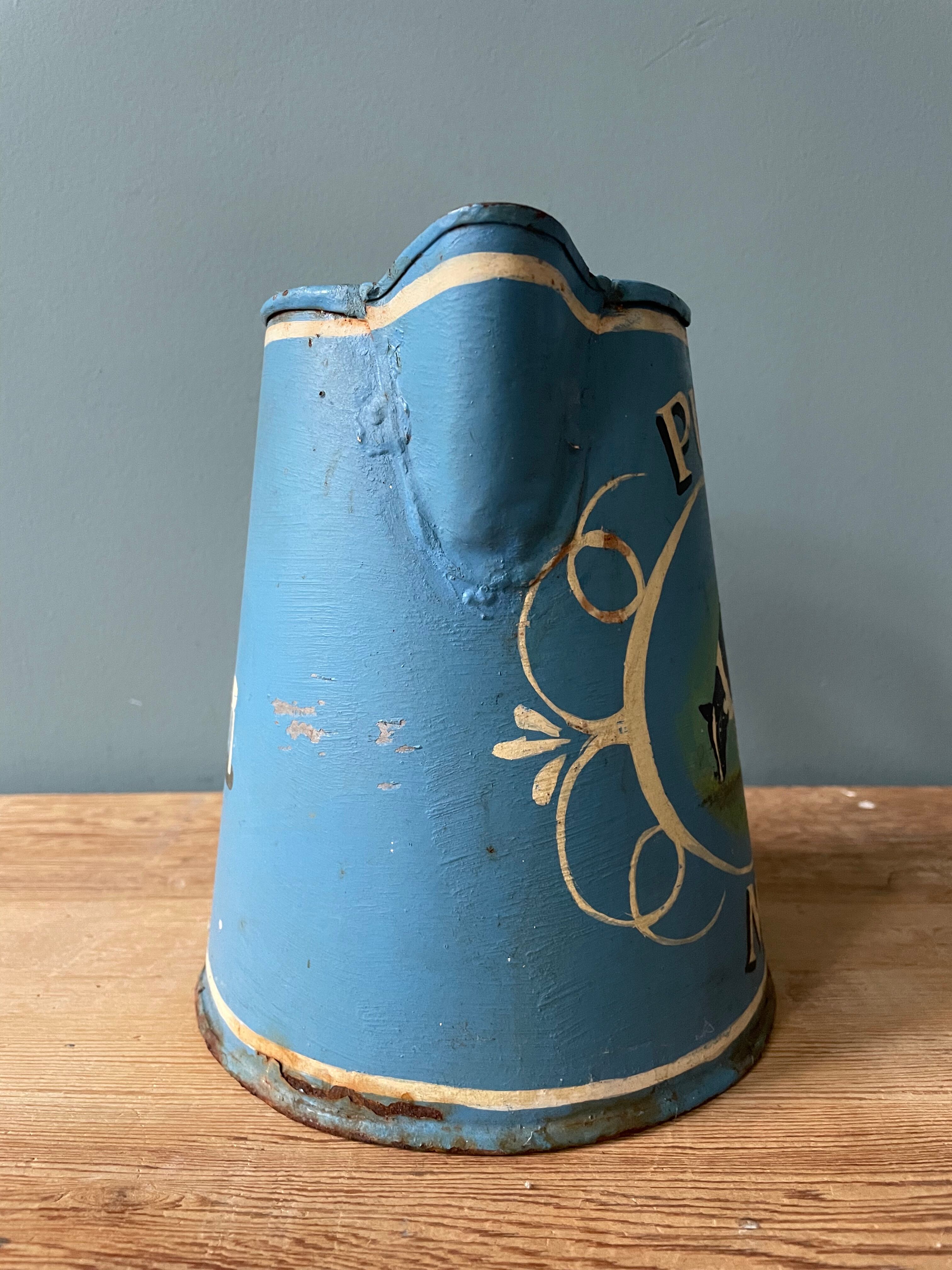 Old painted sheet metal jug or milk jug