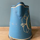 Old pitcher or milk jug in painted sheet metal