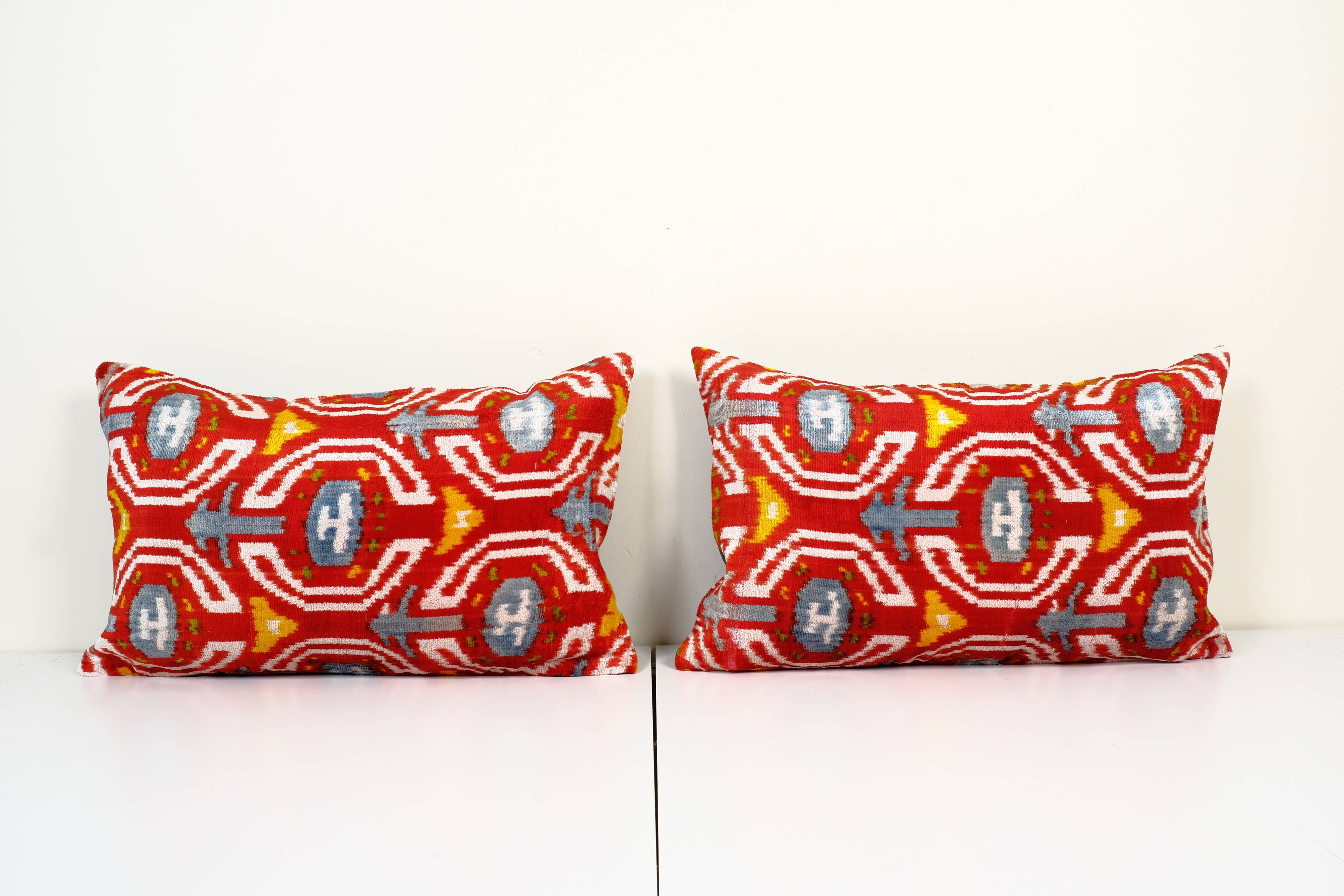 Set of two red ikat velvet lumbar pillows