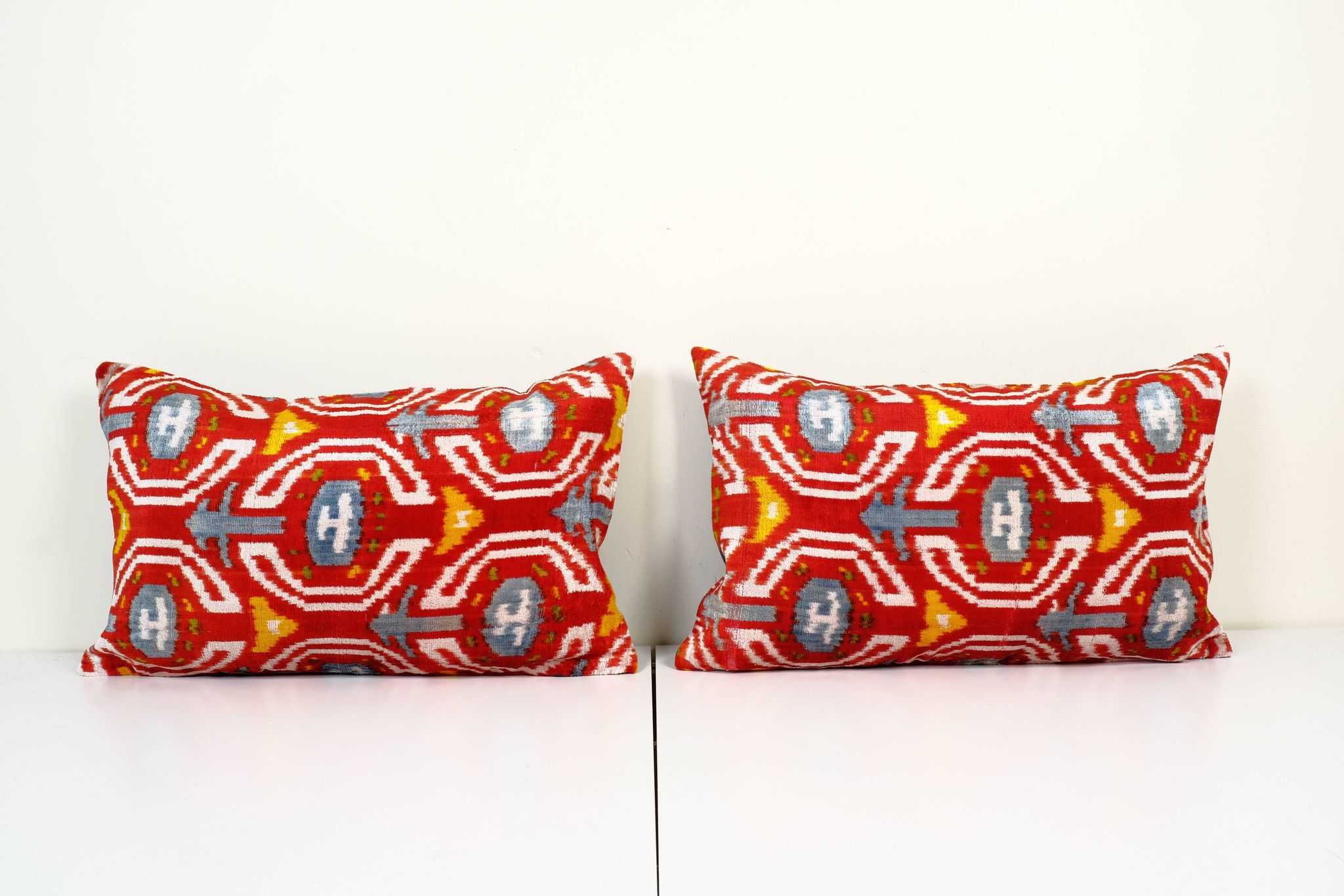Set of two red ikat velvet lumbar pillows