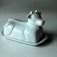 White ceramic butter dish in the shape of a cow, vintage