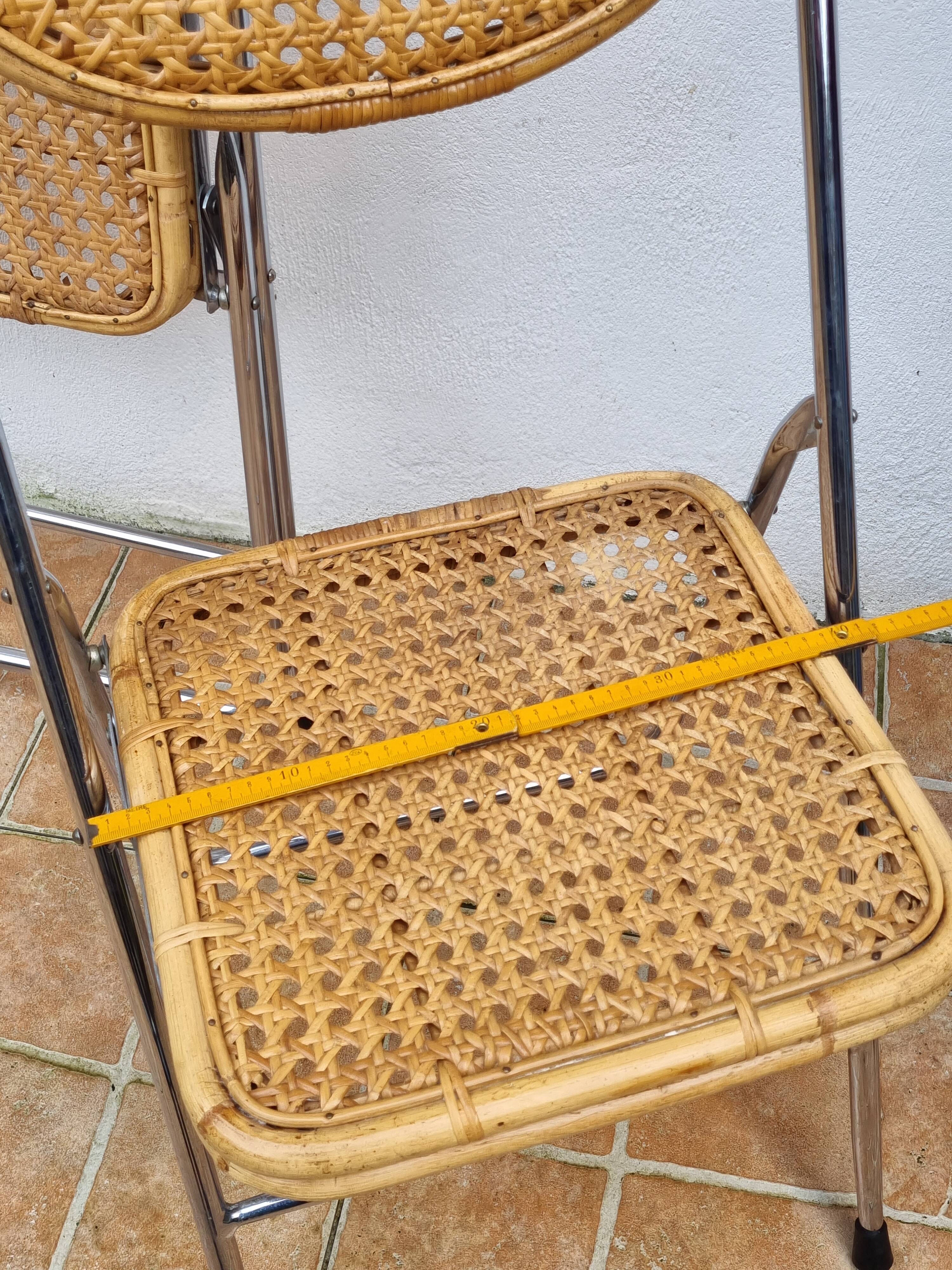 Pair of vintage metal and cane folding chairs