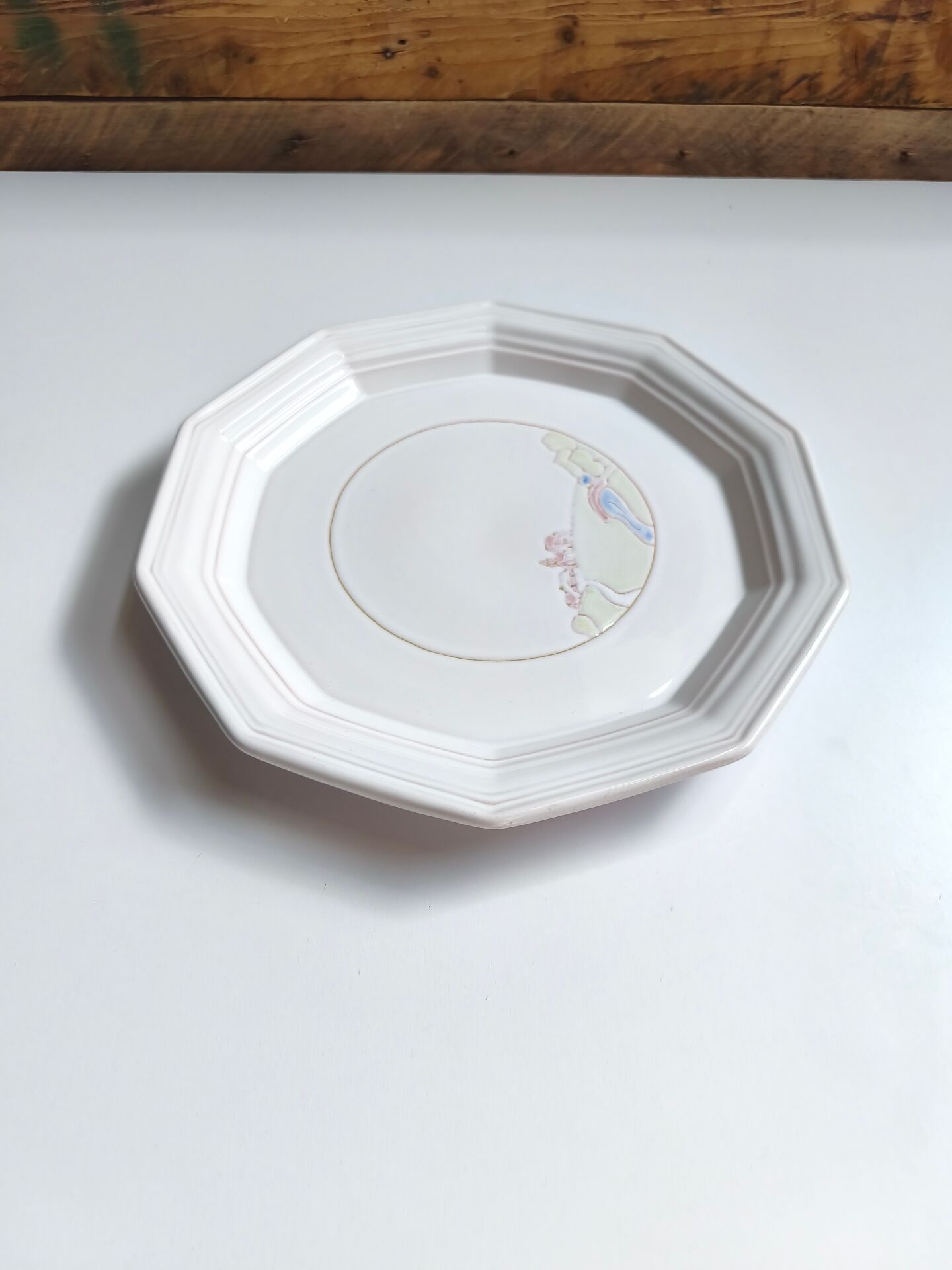 Round vintage Niderviller plate with a country decor.