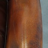 Dark English style sheepskin wingback chair with character and patina