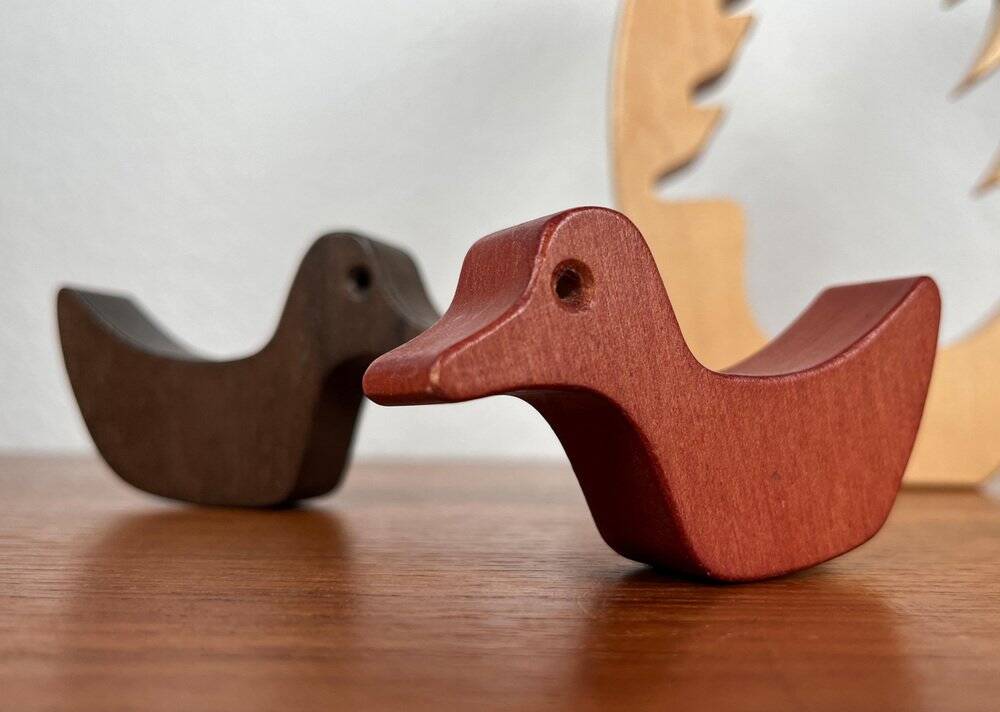 Vintage wooden puzzle with duck figurines.