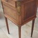 Old wooden bedside table on marble top