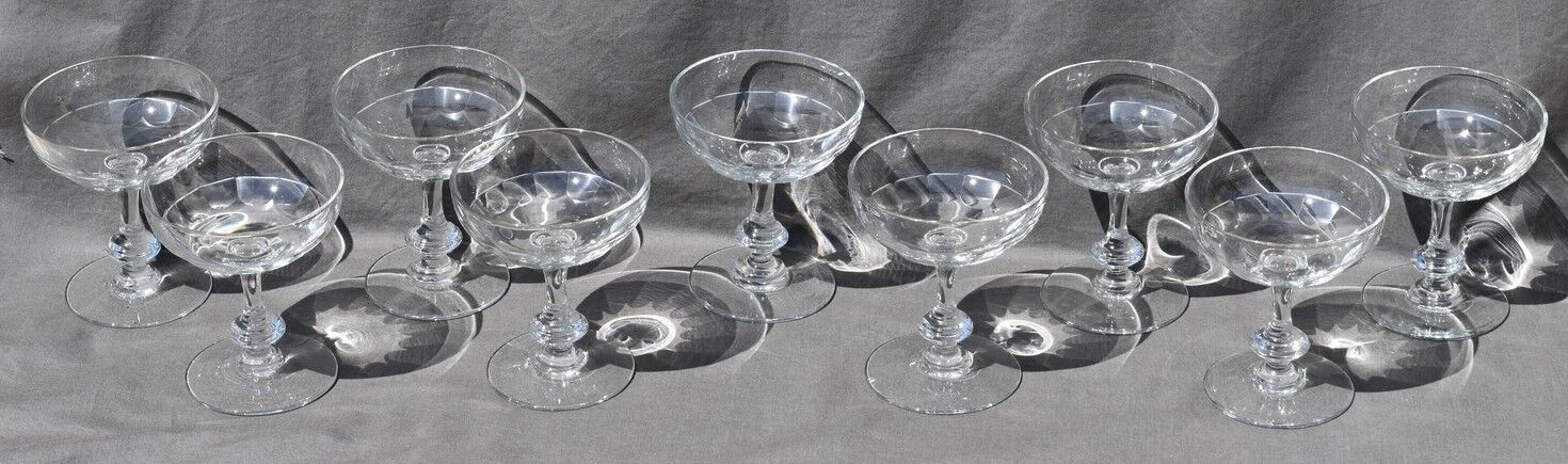 9 old champagne glasses in flat-waisted blown glass