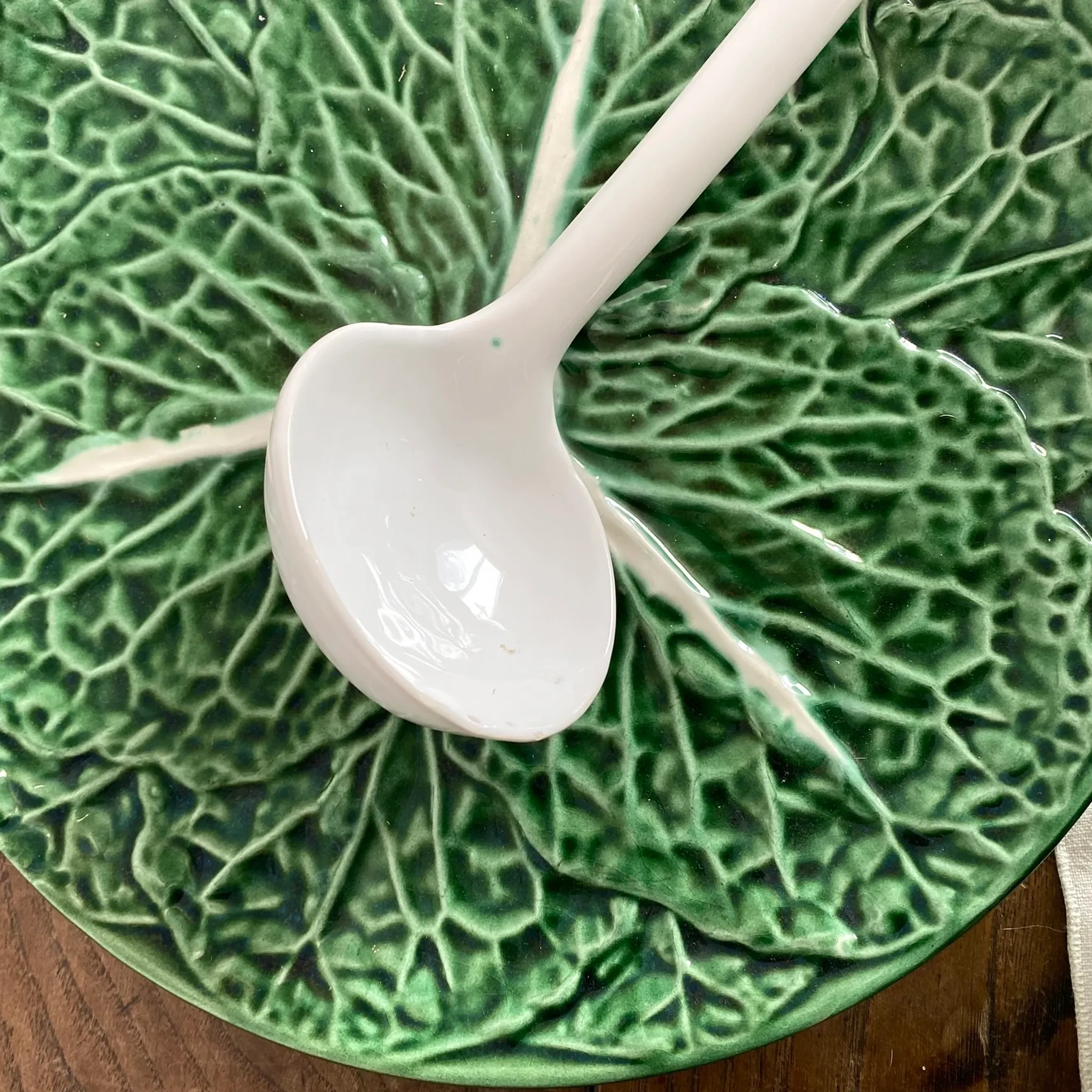 Large soup tureen in earthenware with a cabbage design, along with a dish and spoon.