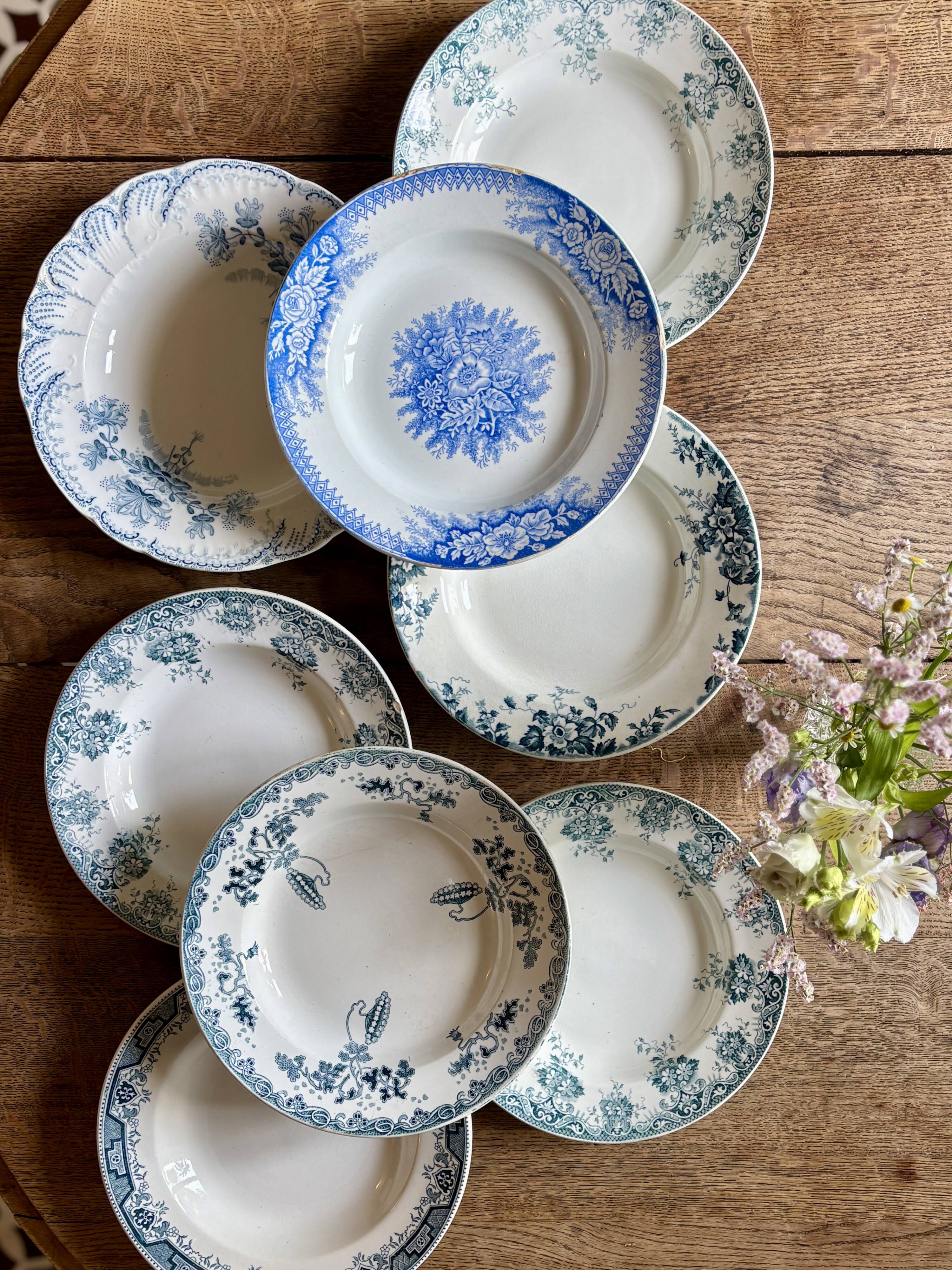 Set of 8 mismatched antique ironstone deep plates.