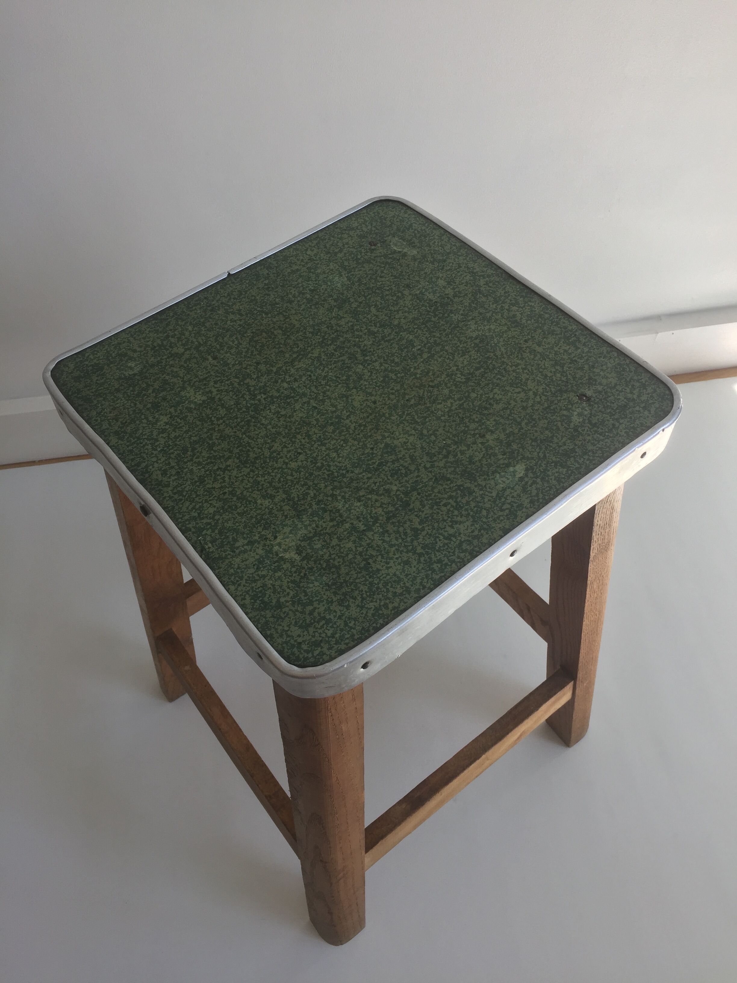 Wooden stool and green seat