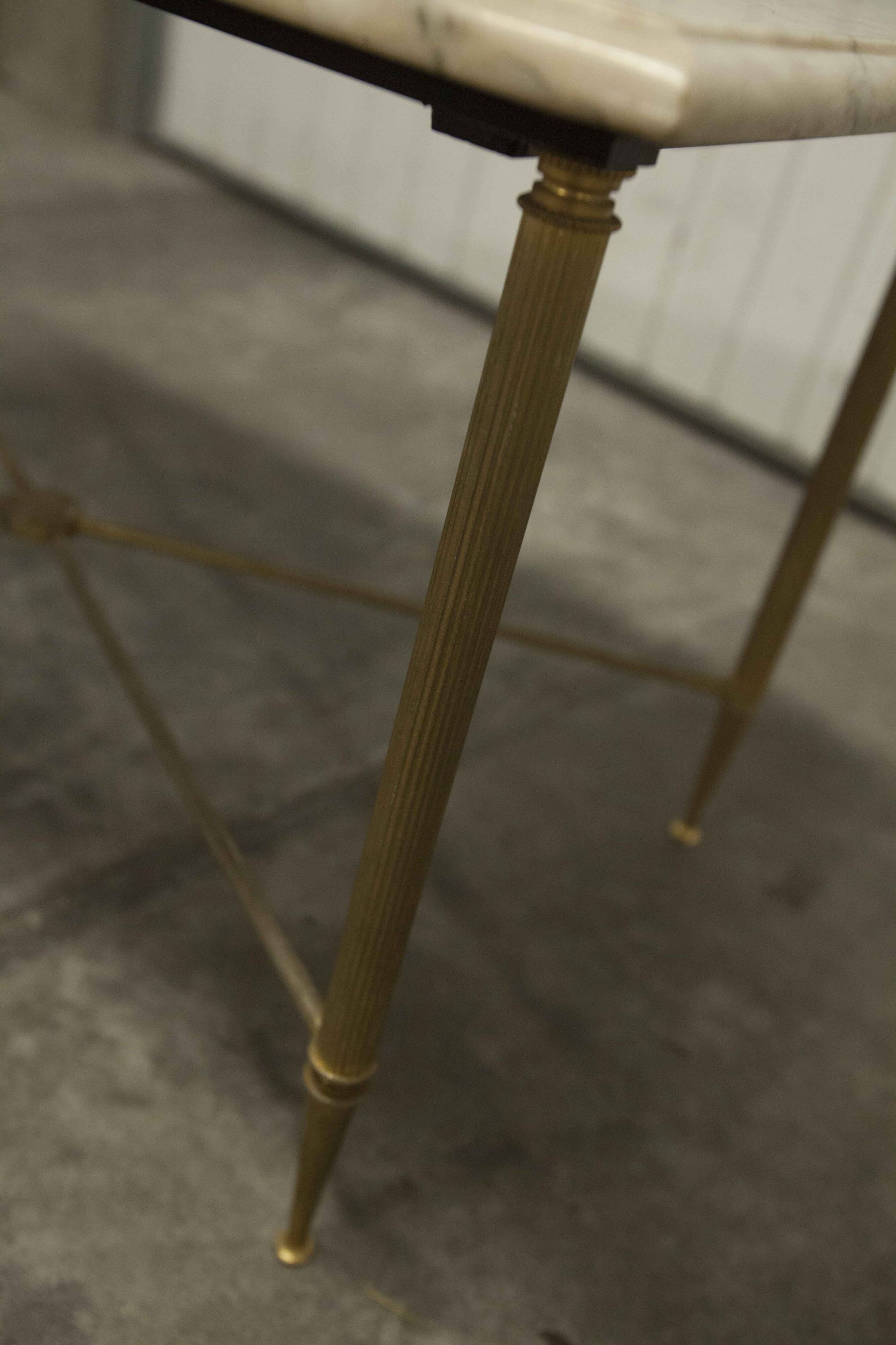 Marble coffee table with brass legs, height 46 cm.