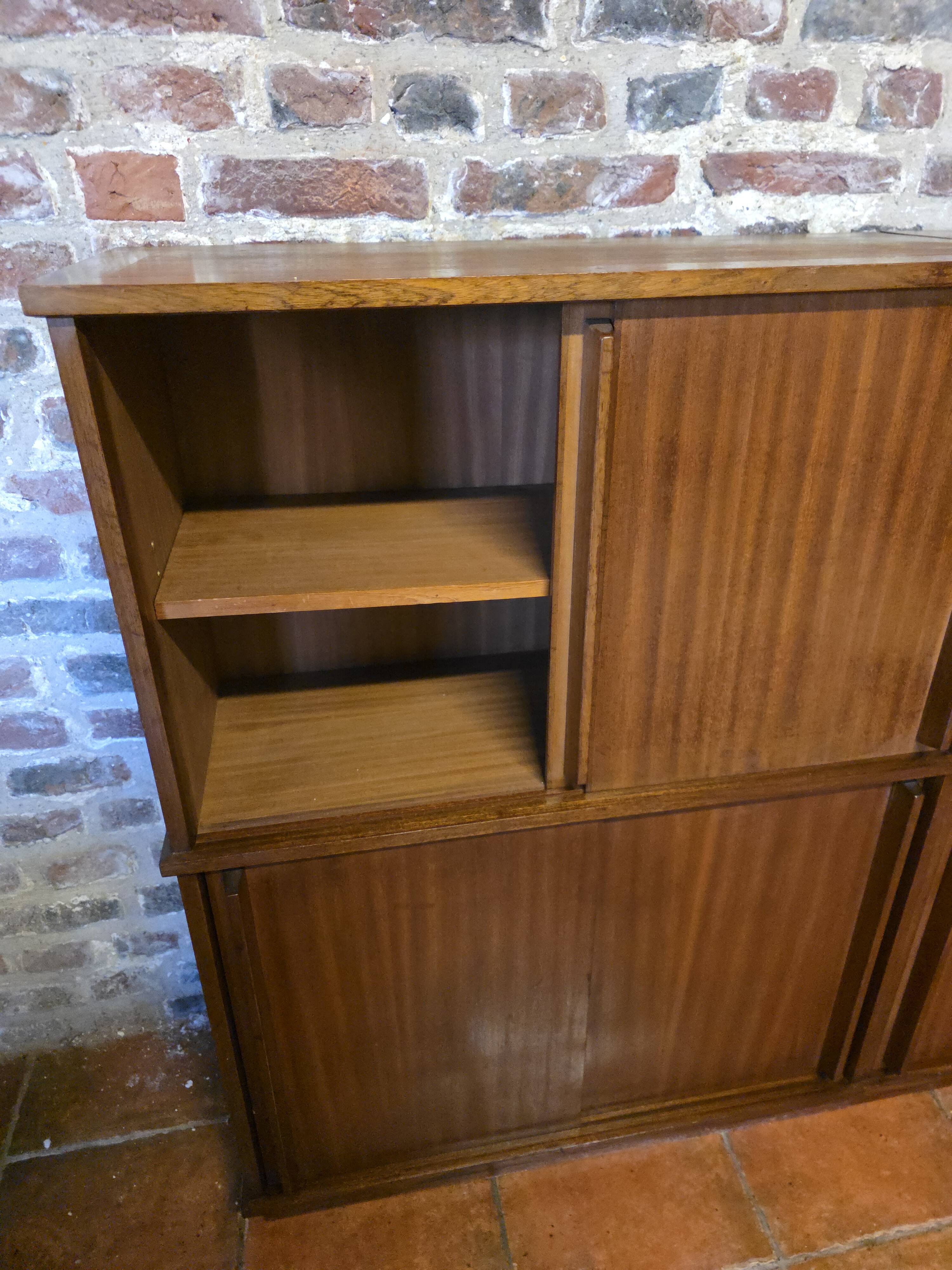 Modular corner library Oscar from the 1960s with sliding doors.