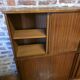 Modular corner library Oscar from the 1960s with sliding doors.